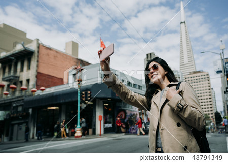 young girl taking selfie standing on road 48794349