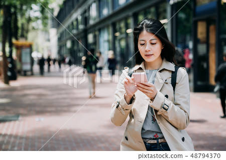 office lady using mobile phone replying email 48794370