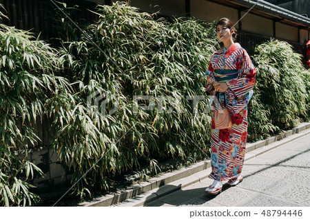 local girl in kimono walking along bamboo garden local girl in kimono walking along bamboo garden 48794446