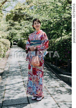 gorgeous woman in path stand in japanese garden gorgeous woman in path stand in japanese garden 48794458