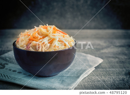 Sauerkraut with carrots in a ceramic Cup. Sauerkraut with carrots in a ceramic Cup. 48795120