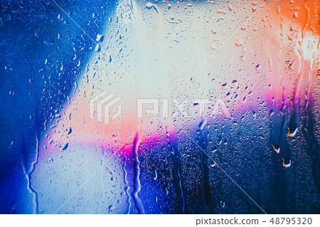 Raindrops on a blurred multicolored background 48795320