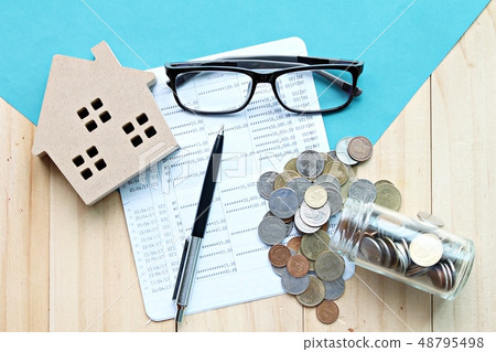 house, financial statements and coins on table 48795498
