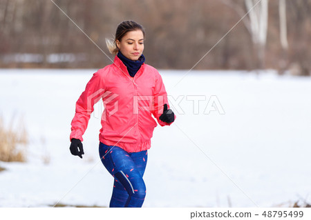 Young girl on trail running training in winter 48795499