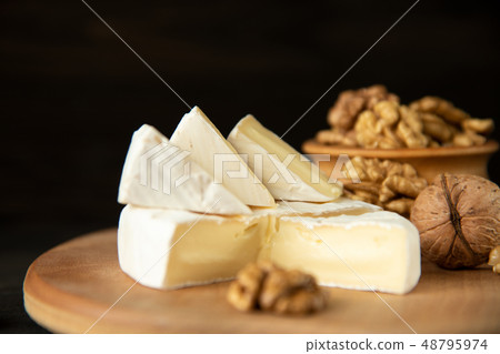 Cheese camembert or brie with walnut kernels Cheese camembert or brie with walnut kernels 48795974