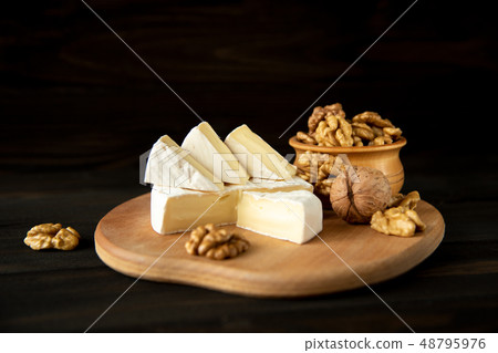 Cheese camembert or brie with walnut kernels Cheese camembert or brie with walnut kernels 48795976