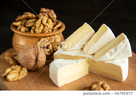 Cheese camembert or brie with walnut kernels Cheese camembert or brie with walnut kernels 48795977