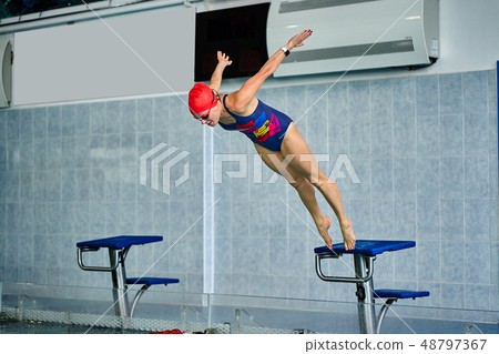 Female athlete jumps to the pool water. Female athlete jumps to the pool water. 48797367
