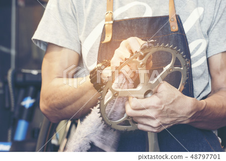 Technician man fixing gear cleaning Technician man fixing gear cleaning 48797701