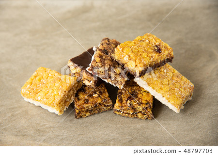 Various muesli bars on marble stone background Various muesli bars on marble stone background 48797703