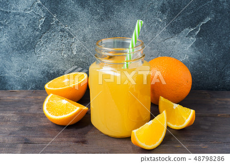 Orange juice in glass jar and fresh fruits oranges Orange juice in glass jar and fresh fruits oranges 48798286