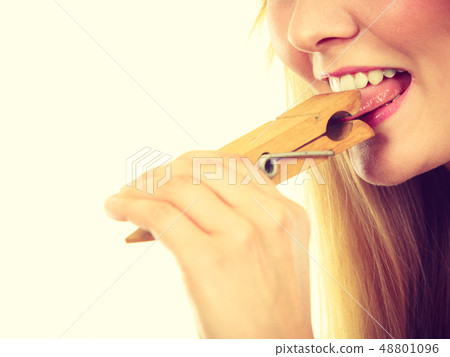 Blonde woman having tongue in clothespin Blonde woman having tongue in clothespin 48801096
