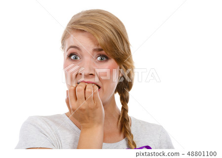 Scared, stressed woman biting her nails Scared, stressed woman biting her nails 48801100