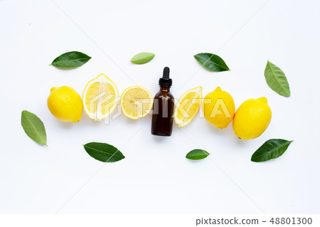 Fresh lemon with lemon essential oil on white Fresh lemon with lemon essential oil on white 48801300