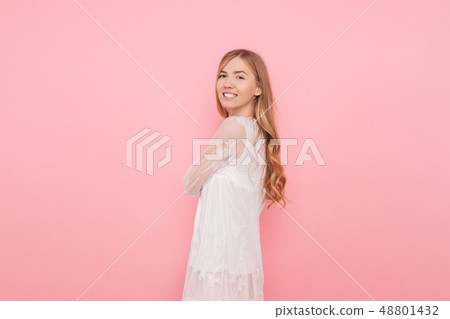 Happy girl with curled hair in a white dress 48801432