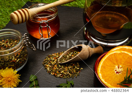 herbal tea and honey over black 48802364