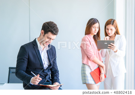 Business man taking note in front of two worker Business man taking note in front of two worker 48802418