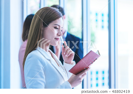 Business people writing idea on a book in meeting 48802419