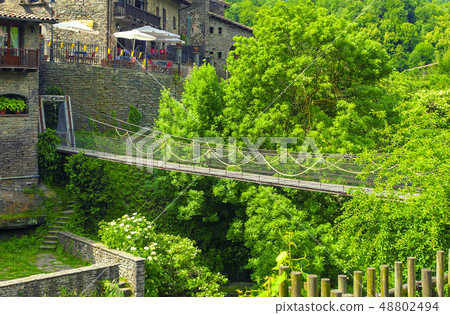 The wooden suspension bridge in the old town 48802494