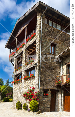 old stone house with flowers on the Windows old stone house with flowers on the Windows 48802516