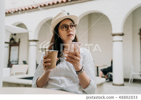 woman relaxing outdoor cafe in afternoon tea time 48802833