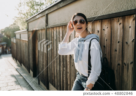 japanese woman tour guide relying on wooden wall japanese woman tour guide relying on wooden wall 48802846