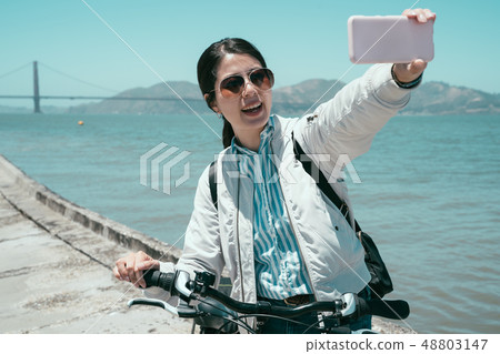 Happy young female tourist taking selfie Happy young female tourist taking selfie 48803147