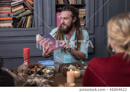 Nice serious man opening the page in the book 48804622