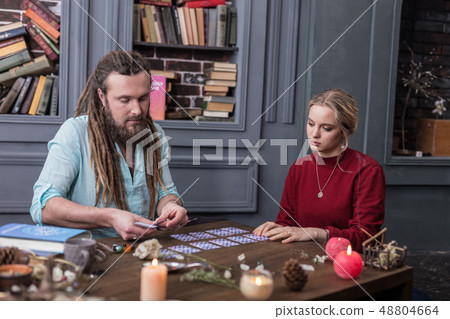 Pleasant serious man putting cards on the table 48804664