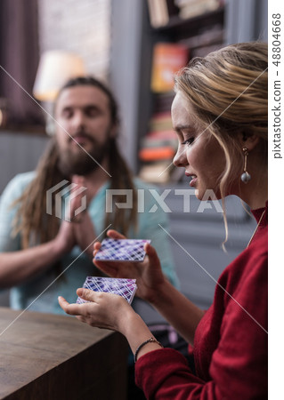 Nice young blonde woman shuffling the cards 48804668