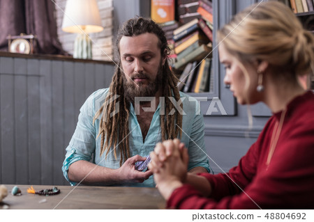 Nice serious fortune teller looking at the cards 48804692