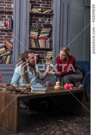 Pleasant smart fortune teller speaking with his visitor 48804699