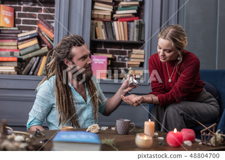 Nice pleasant man giving special seeds to his visitor 48804700