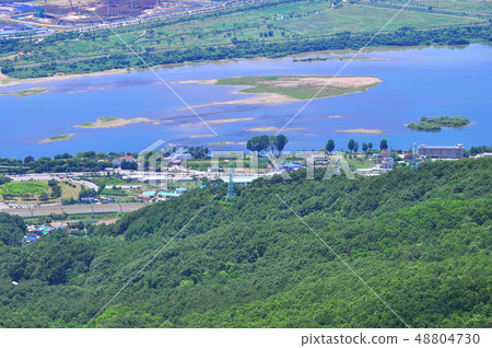 Beautiful riverside scenery of a village in harmony with the river seen from a mountain on a clear day 48804730