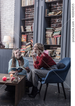 Cheerful young woman having a dreamy look 48804855