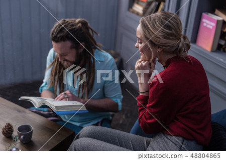 Positive delighted blonde woman touching her chin 48804865