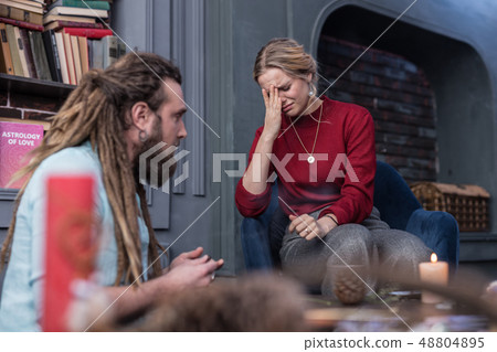 Depressed gloomy young woman holding her forehead 48804895