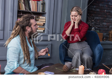 Sad unhappy woman sitting in the armchair 48804906