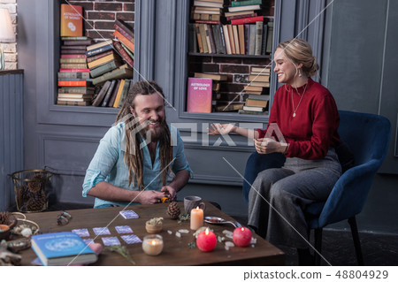 Positive happy woman speaking to the fortune teller 48804929