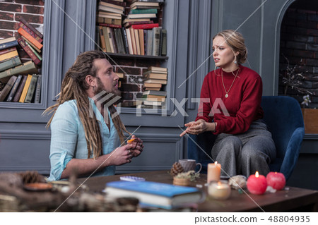 Sad cheerless woman visiting a fortune teller 48804935