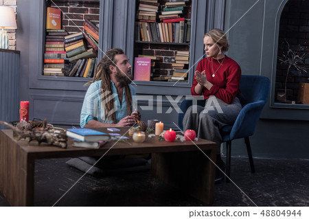 Nice young woman asking fortune teller for help 48804944