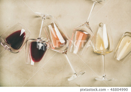 Red, rose and white wine in glasses over grey 48804990