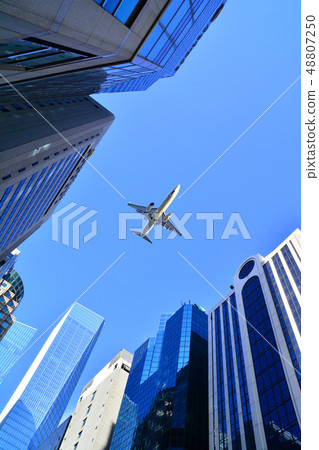Jet aircraft flying over the skies of Seoul's landmarks, high-rise buildings 48807250