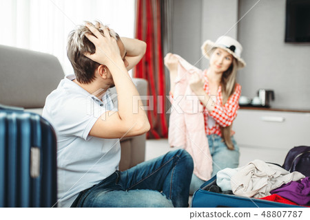 Husband and wife packing suitcases for vacation Husband and wife packing suitcases for vacation 48807787