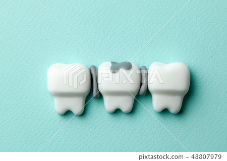Healthy white teeth and tooth with caries on green mint background. Healthy white teeth and tooth with caries on green mint background. 48807979