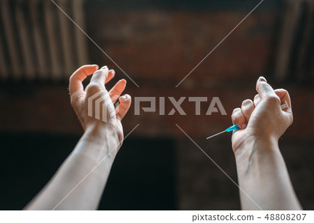 Junkie hands with syringe, drug addiction concept Junkie hands with syringe, drug addiction concept 48808207
