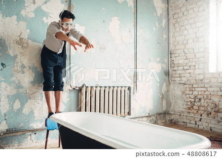 Businessman in flippers dives into the bathtub 48808617