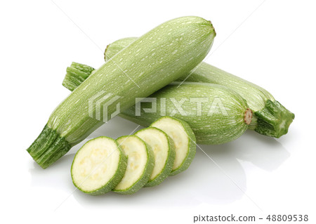 Green zucchini with slices isolated on white Green zucchini with slices isolated on white 48809538