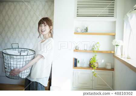 Woman with laundry Woman with laundry 48810302