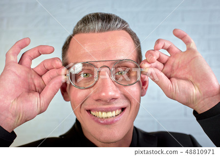 Closeup portrait of a happy young businessman with glasses looking at the camera on white background Closeup portrait of a happy young businessman with glasses looking at the camera on white background 48810971